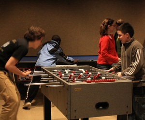 TUTORS member first-year Jim Price plays foosball with one of the participating students, who halls from Mexico.